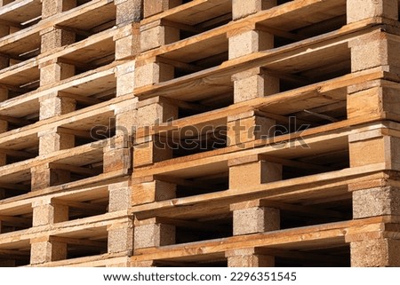 Close-up of a lot of wooden pallets for transporting various goods and materials.