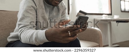 Black man holding credit card for online shopping and payment makes a purchase on the Internet, Online payment, Business financial and technology