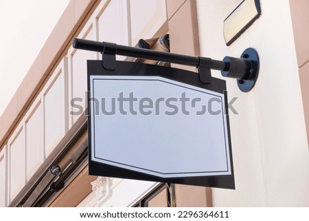Mock up. Blank white rectangular signboard store, shop, cafe, restaurant, office. Mockup advertising logo signage on building wall outdoors