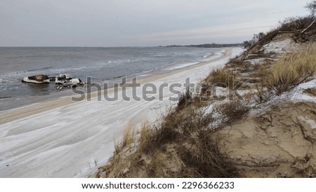 The coast of the Baltic Sea on the Curonian Spit is covered with snow Royalty-Free Stock Photo #2296366233