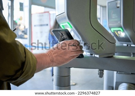 Person using qr code or smartphone app to enter an airport or convention hall, office, or any area with security control Royalty-Free Stock Photo #2296374827