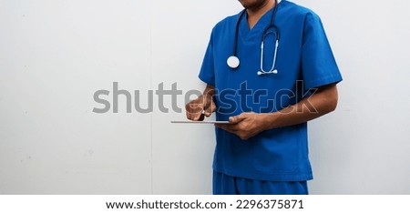 Smart medicine doctor working with  digital tablet at desk in the hospital. Isolated Nurse in blue in medical uniform on white background. Medical concept