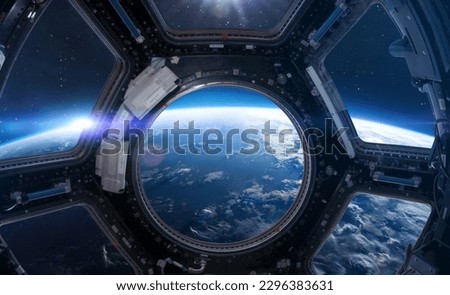 Cupola porthole on space station. ISS window. International space station. Earth planet with stars view. Elements of this image furnished by NASA