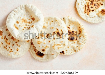 Lebanese pita bread. Arab Bread. Close up, Top view, flat lay. Royalty-Free Stock Photo #2296386129