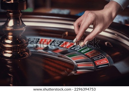 American roulette table, the dealer puts Dolly on the winning number Royalty-Free Stock Photo #2296394753