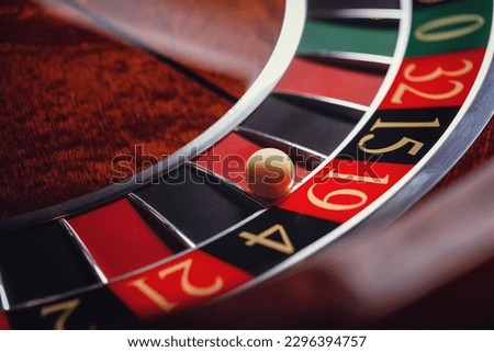 Casino roulette, close-up of a roulette ball, sectors red and black  Royalty-Free Stock Photo #2296394757