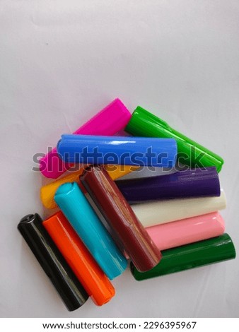 Huge stack of different colored cap sketch pen placed on a white paper background.