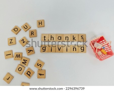 Thanksgiving concept, The word thanksgiving is printed on a wooden cube, isolated on white.