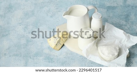 Different dairy products on light blue background with space for text Royalty-Free Stock Photo #2296401517
