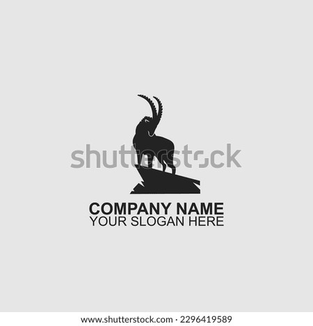 Logo design of a mountain goat standing on a mountain proudly. Silhouette of a dashing mountain goat. Royalty-Free Stock Photo #2296419589
