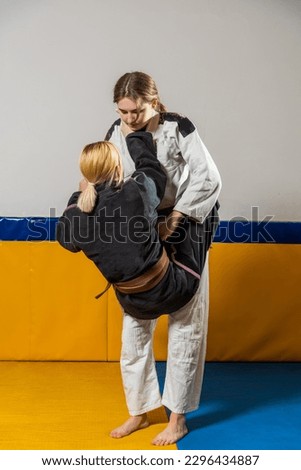 Young girls practice Brazilian jiu jitsu in the gym