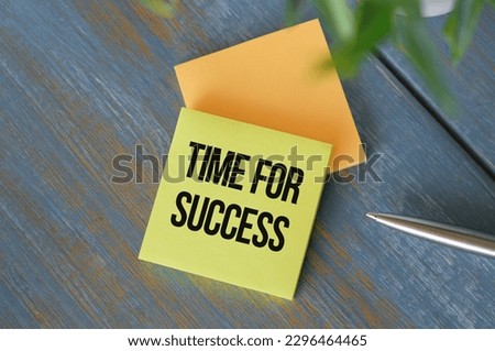 Time for Success text message with pen on wooden background