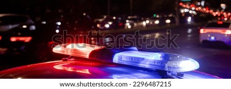 police car lights at night in city background
