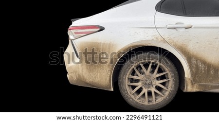 Side view of a very dirty car. Fragment of a dirty car. Dirty headlights, wheel and bumper of the car with swamp splashes on a side panel Royalty-Free Stock Photo #2296491121