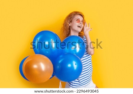 party girl with balloon in sunglasses. happy girl hold helium balloons in studio.