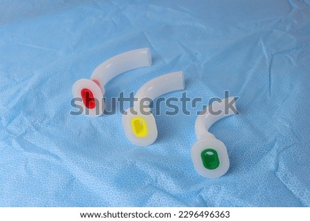 Different sizes of an Oropharyngeal airway above a surgical field  Royalty-Free Stock Photo #2296496363