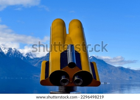 a panoramic binoculars, binoculars used to see the beautiful scenery of mountains and lakes in a town called montreux, 30 march 2023, switzerland Royalty-Free Stock Photo #2296498219