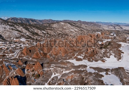 amazing landscape capture of red rock mountain landscape during a bright blue winter day from a drone