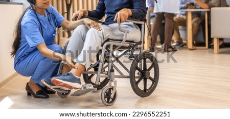 Portrait of asian woman physiotherapist carer helping physical and discussing consulting talk with senior woman patient by doing exercises sitting in wheelchair in rehabilitation at hospital