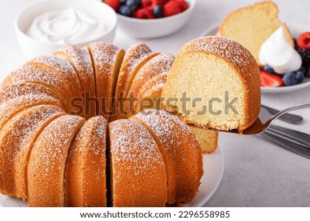 Pound cake baked in a bundt pan, traditional vanilla or sour cream flavor, dusted with powdered sugar Royalty-Free Stock Photo #2296558985