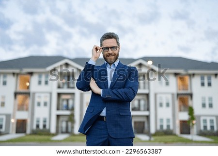 photo of cheerful man realtor. man realtor at the house. man realtor in the suit. man realtor