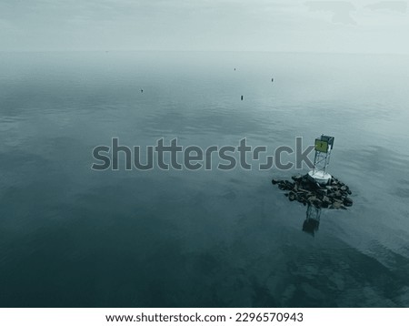 Foggy morning and calm seas at Black Rock Harbor Royalty-Free Stock Photo #2296570943