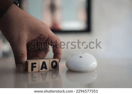 Wooden blocks with word FAQ with a computer mouse. FAQ abbreviation, frequently asked questions. Collection of frequently asked questions on any topic and answers to them. Instructions and rules Royalty-Free Stock Photo #2296577351