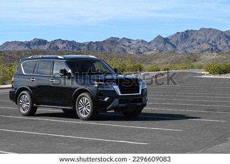 Black SUV parked in a car park in the desert of Nevada. 