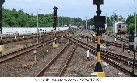 Railroad track with switches and junctions on the main line station in Cirebon Station, West Java, Indonesia, geometric structure, thresholds, gravel, and screws