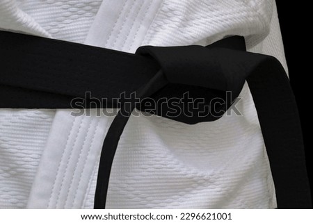 Close-up on a black belt tied around a kimono. Royalty-Free Stock Photo #2296621001