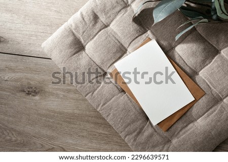 Blank paper card mockup, minimalist aesthetic business template with postcard and envelope on a beige interior pillow background, copy space