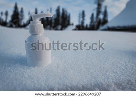 cosmetic cream bottle package mockup on white snow with Finland background 