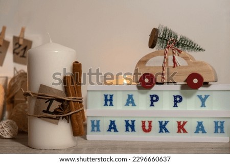 Candles with advent calendar Lightbox with text HAPPY HANUKKAH Traditional Burning Christmas Wax Candles with numbers counting down for Christmas. Beautiful Advent At Home. Festive Candlelight And
