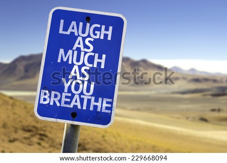 Laugh As Much As You Breathe sign with a desert background