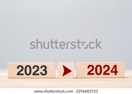 2024 and 2023 wooden block on table background. Resolution, strategy, countdown, goal, change and New Year holiday concepts