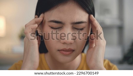 Asian Young woman suffering from cold, Sick with flu, sneezing into tissue from allergies, she has severe headache temperature, Unhealthy female getting flu virus symptom Cold and fever at home