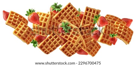 Belgian waffles with fresh strawberries in motion isolated on a white background.