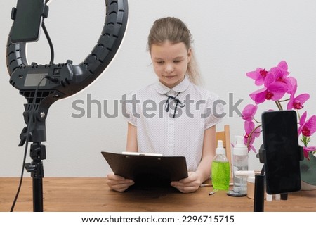 a beautiful young blogger girl is preparing for a report reading a script