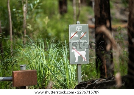 No dogs allowed signs, on a bush walking track in Australia 
