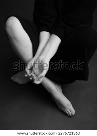 Refined and elegant hands of a dancer, dancing with body parts, black and white portrait of the performer's hands on a dark background Royalty-Free Stock Photo #2296721363