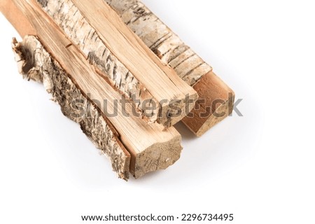 Stack of logs firewood from silver birch tree isolated on white background Royalty-Free Stock Photo #2296734495