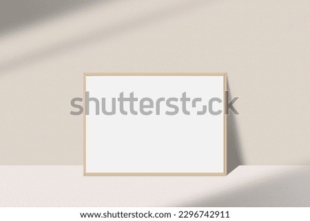 Realistic landscape photo frame mockup. Wooden frame mockup on the table with light window shadow overlay effect. Simple, clean, modern, minimal empty poster frame mock up. White picture frame mockup