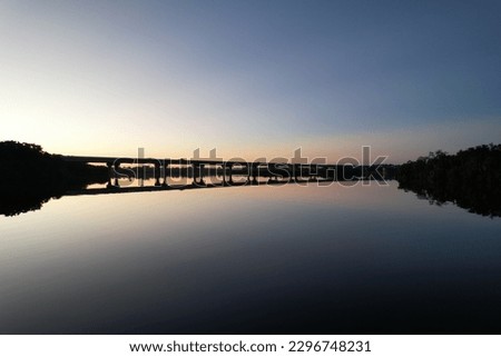 The view of Fort Hamer Bridge under the blue sky reflected in the water at sunset
