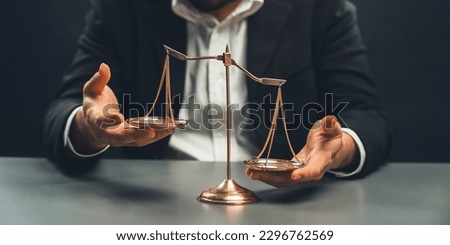 Lawyer or judge in formal black suit hold unbalanced scale with expression of disappointment trying to fix imbalance as anti-injustice concept to fight against corruption of legal system. equility Royalty-Free Stock Photo #2296762569