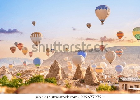 Beautiful landscape of fabulous scenic Kapadokya, Nevsehir. Colorful fairy flying air balloons in sky at sunrise in Anatolia, Goreme 