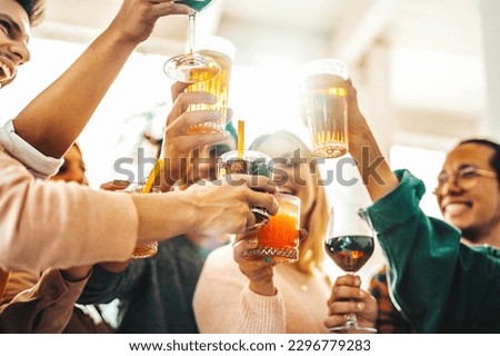 Multiracial friends celebrating party drinking cocktails at bar restaurant - Young people having fun hanging out on weekend day - Life style concept with guys and girls enjoying time together Royalty-Free Stock Photo #2296779283