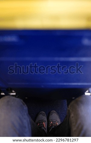 Vertical picture of small and narrow aircraft seat. Problem to fit legs. It is designed for budget travelers who don't mind to sacrifice comfort for affordability instead of legroom. Royalty-Free Stock Photo #2296781297