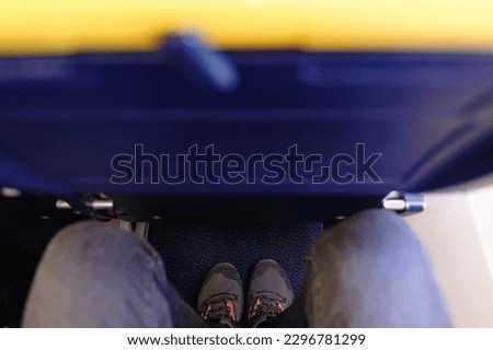 Vertical picture of small and narrow aircraft seat. Problem to fit legs. It is designed for budget travelers who don't mind to sacrifice comfort for affordability instead of legroom. Royalty-Free Stock Photo #2296781299