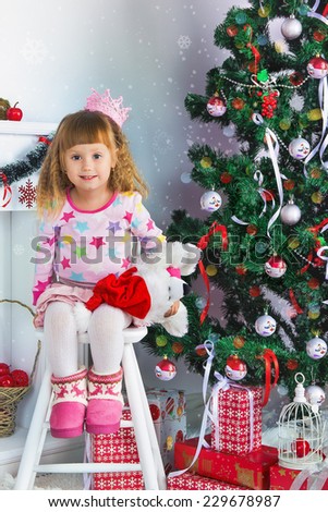 Happy little girl near the Christmas tree
