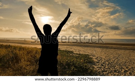 
Silhouette of a woman on the beach at sunrise